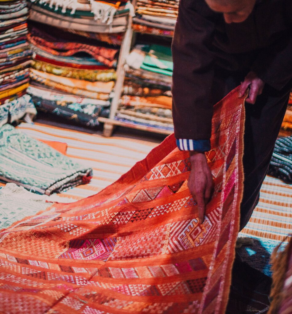 Seller showing carpet in market